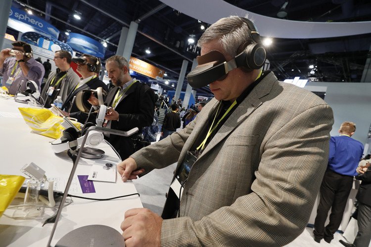 Visitors to CES 2017 in Las Vegas test out some VR headsets